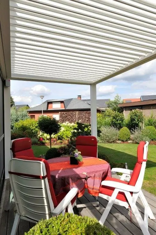 1500 Series Outdoor Shelter above a deck in a backyard garden