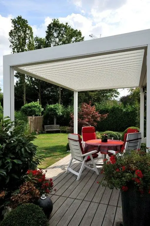 1500 Series Outdoor Shelter above a deck in a backyard garden