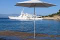 P50 Umbrella on a dock in Greece with a yacht on the water in the background