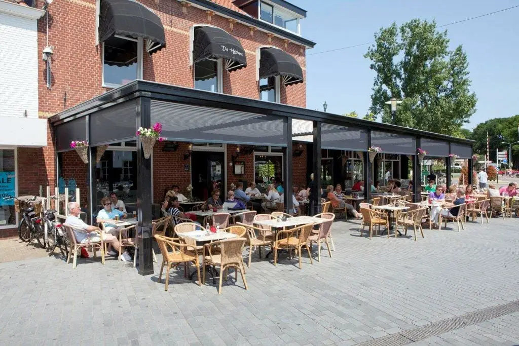 2000 series outdoor shelter covering an outdoor seating area with the shades up