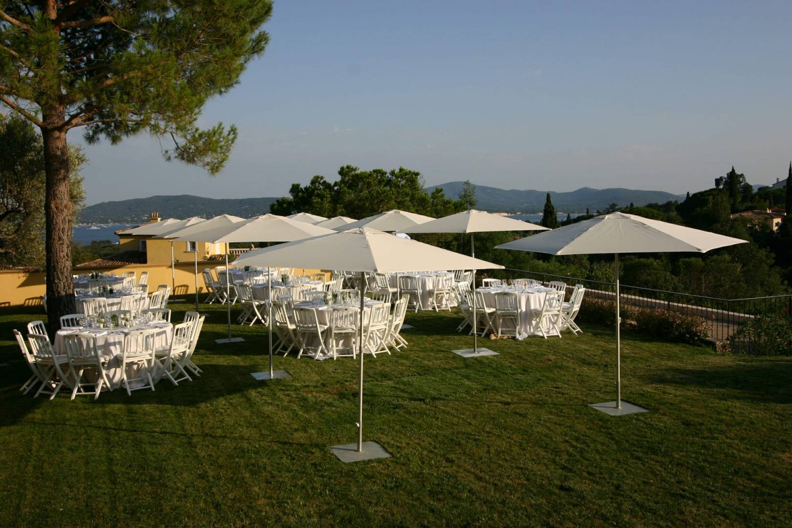 outdoor wedding setup with tables, and p50 umbrellas