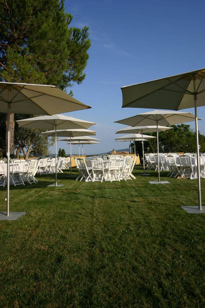 outdoor wedding setup with tables, and p50 umbrellas