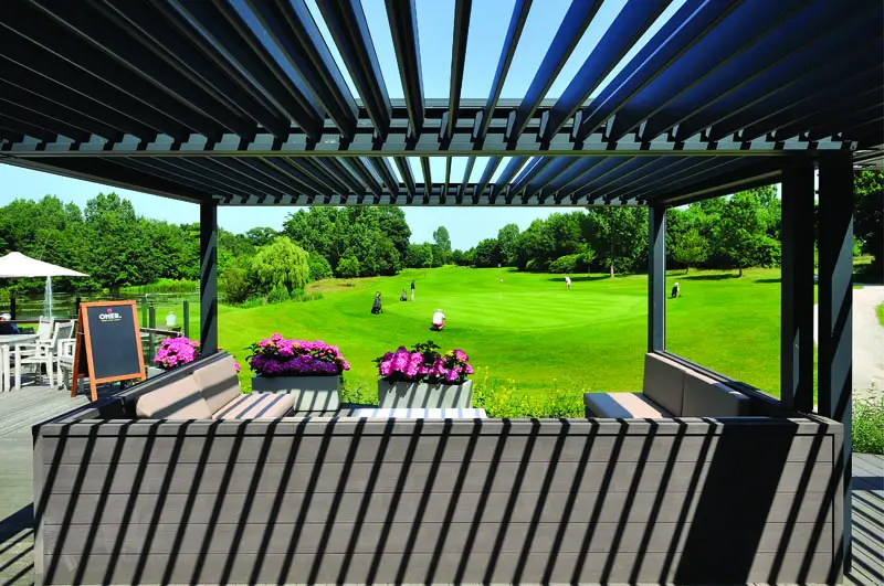 2000 Series Outdoor Shelter over an outdoor seating area looking out at a golf course