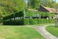 2000 Series Outdoor Shelter with some decorative landscaping to hide it