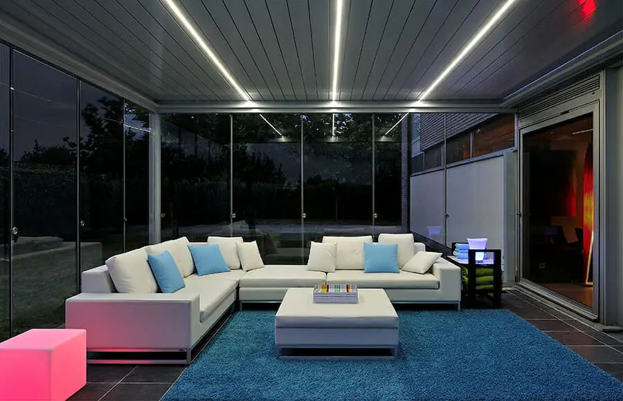 2000 Series Outdoor Shelter covering a seating area. lit up with lights at dusk