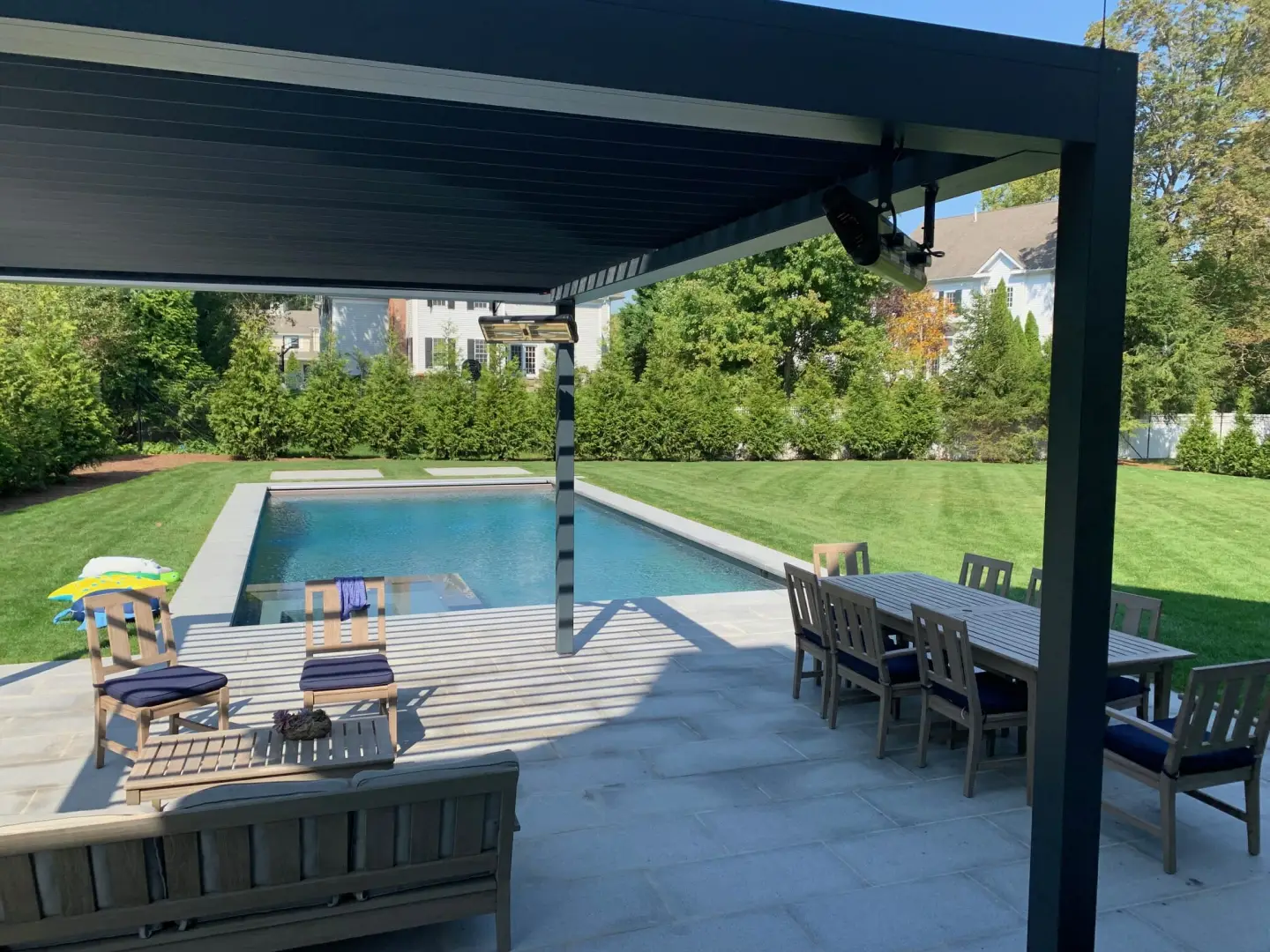 2000 series outdoor shelter attached to the back of a home and covering a patio area