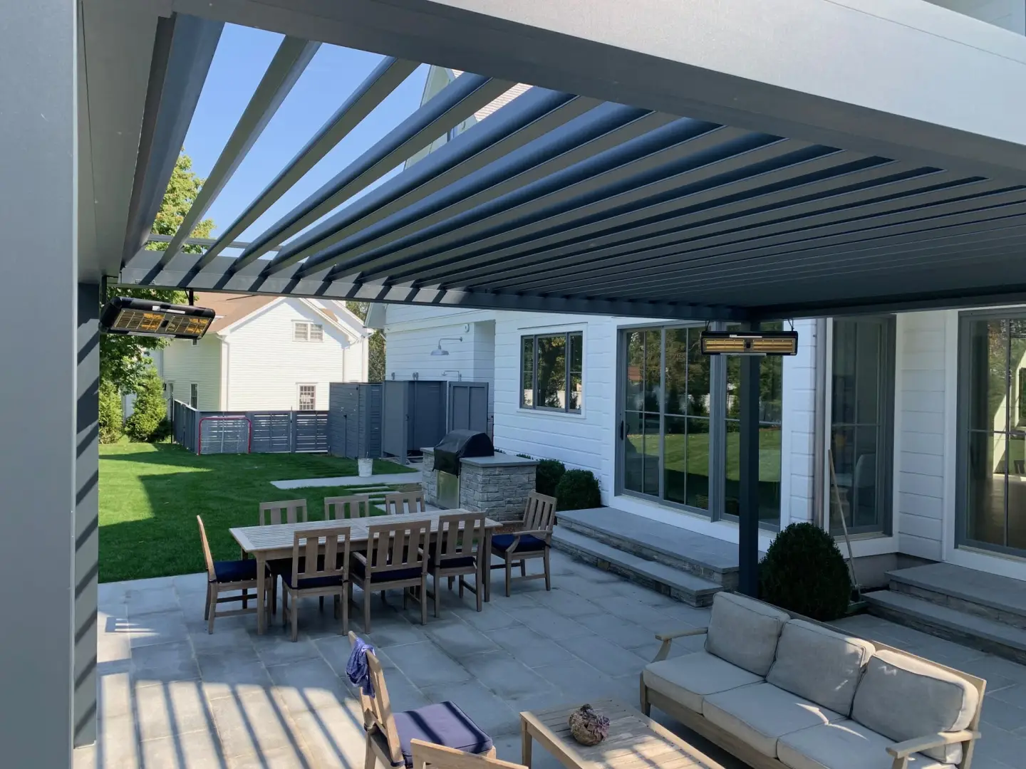 2000 series outdoor shelter attached to the back of a home and covering a patio area