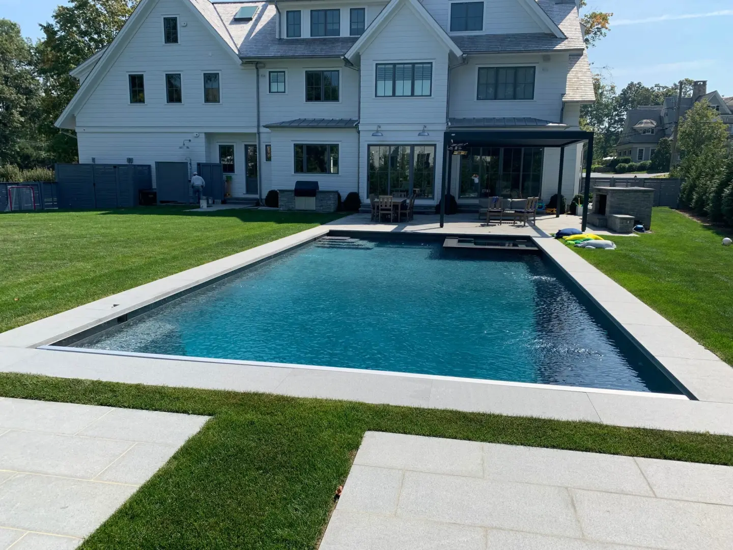 2000 series outdoor shelter behind a home and next to a pool