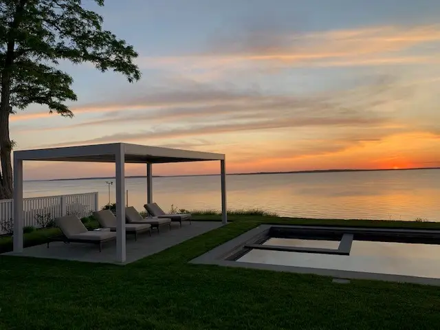 2000 series outdoor shelter covering four pool lounge chairs at dawn