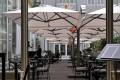 cantilevered commercial umbrellas over outdoor restaurant seating