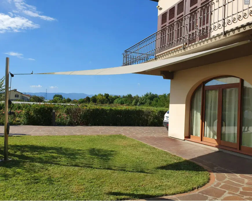 Velart Sail Shade providing shade attached to a building providing shade at the entrance