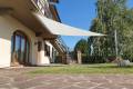 Velart Sail Shade under a deck covering a grassy area