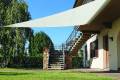 Velart Sail Shade attached to the underside of a deck and overhanging a grassy area