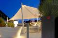 Velora Sail Shade providing protection over an outdoor seating area