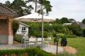 P7 umbrella with white canopy shading an outdoor dining area