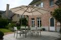 P7 umbrella with white canopy shading an outdoor dining area