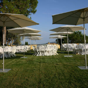 outdoor wedding setup with tables, and p50 umbrellas