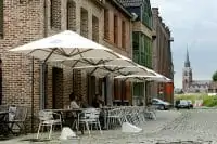 p6 square duo umbrellas covering outdoor dining areas next to a building