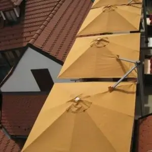 looking down on 4 p6 square duo umbrellas above a rooftop deck