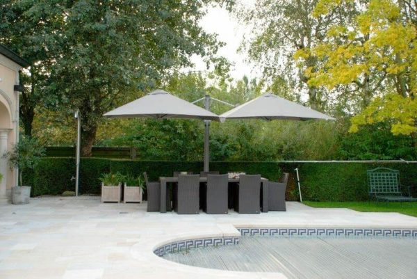 p6 square duo umbrellas covering a large outdoor dining table next to a pool