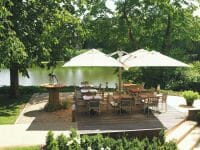 P6 Square Quattro Umbrellas at an outdoor dining area by the water