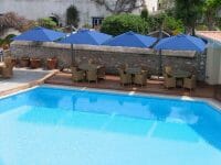 Blue P6 Square Duo Umbrellas covering poolside outdoor seating