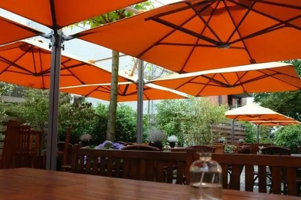 Orange P6 Square Quattro Umbrellas at an outdoor dining area