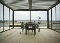 2000 Series Outdoor Shelter protecting a private dinner area in Norway from the elements