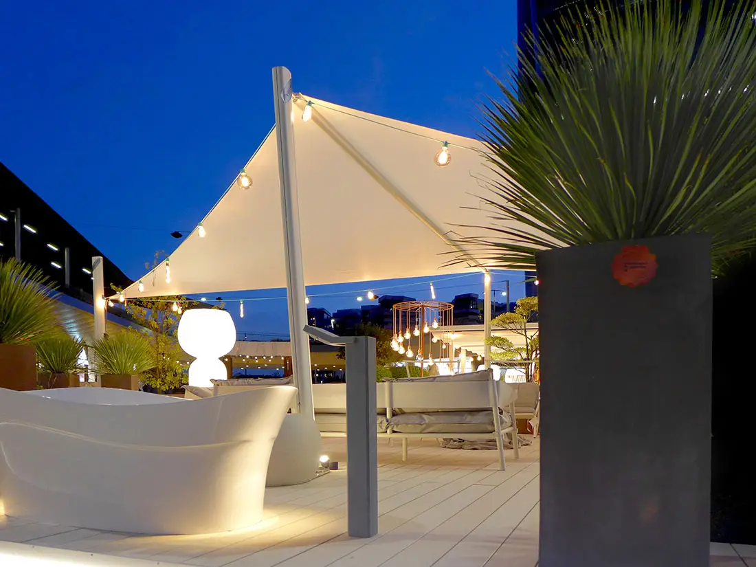 Velora Sail Shade providing protection over an outdoor seating area