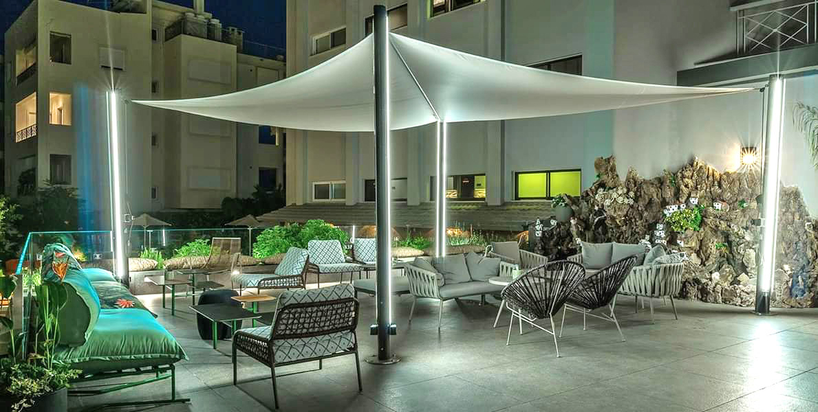 Velora Sail Shade providing protection over an outdoor seating area